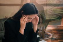 Photo of a woman with her hands on her head