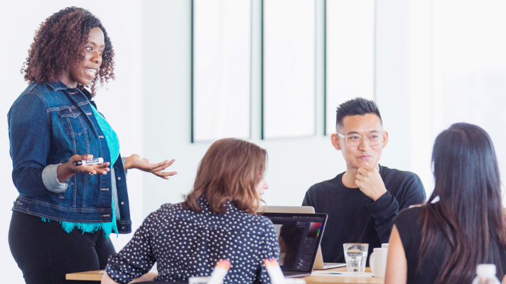 Photograph of a person presenting to a group.