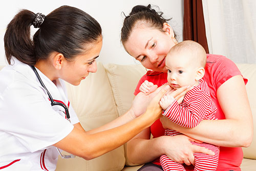 Photograph of a woman and child consulting with a healthcare provider.