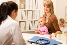 Photograph of women with small child and a medical provider.