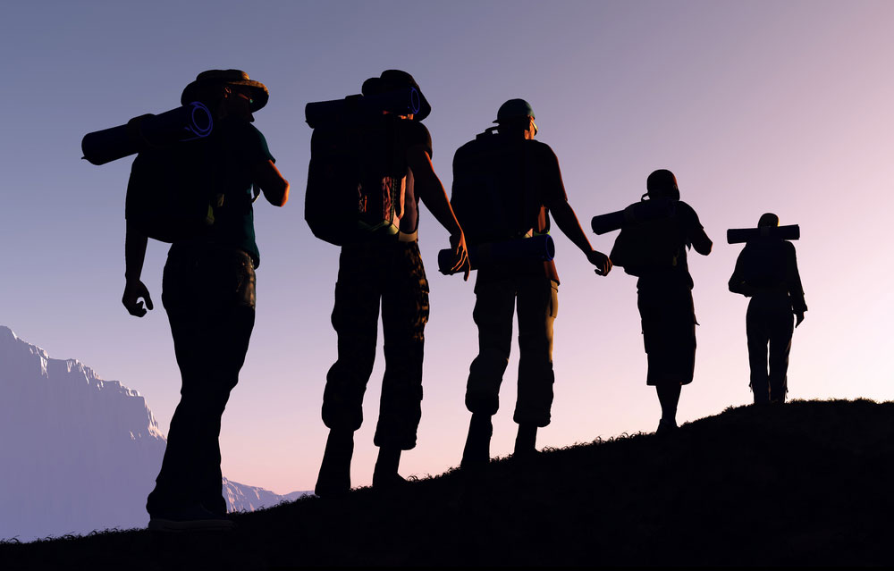 Photograph of several people ascending a mountain trail.