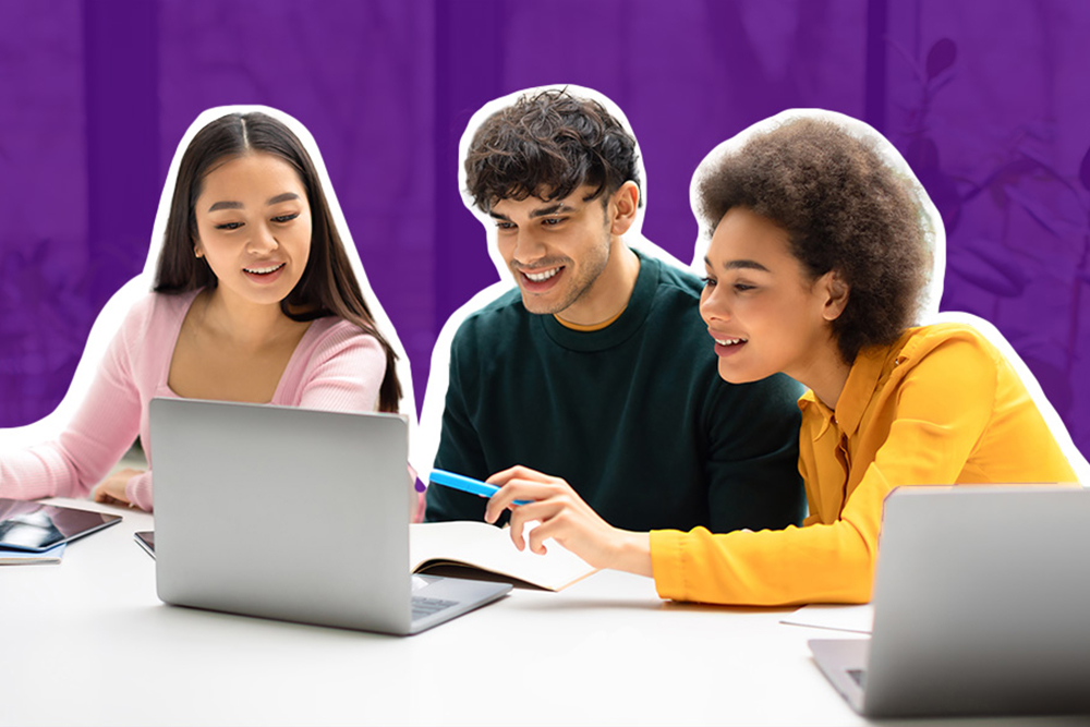 Photograph of students looking at laptop